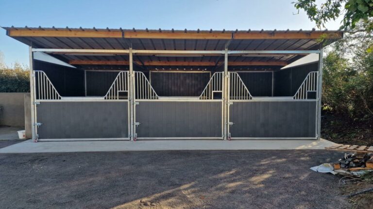 Exterior view of three resin Horse Stables in a row