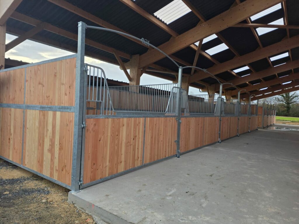 Gooseneck stable front with full-opening door, custom-length bars for mechanical mucking-out