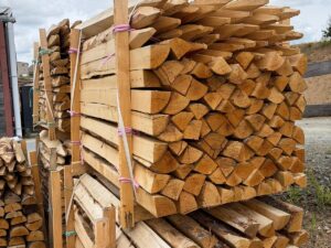 Split chestnut quarter-poles for agricultural and equestrian fencing, and landscaping.