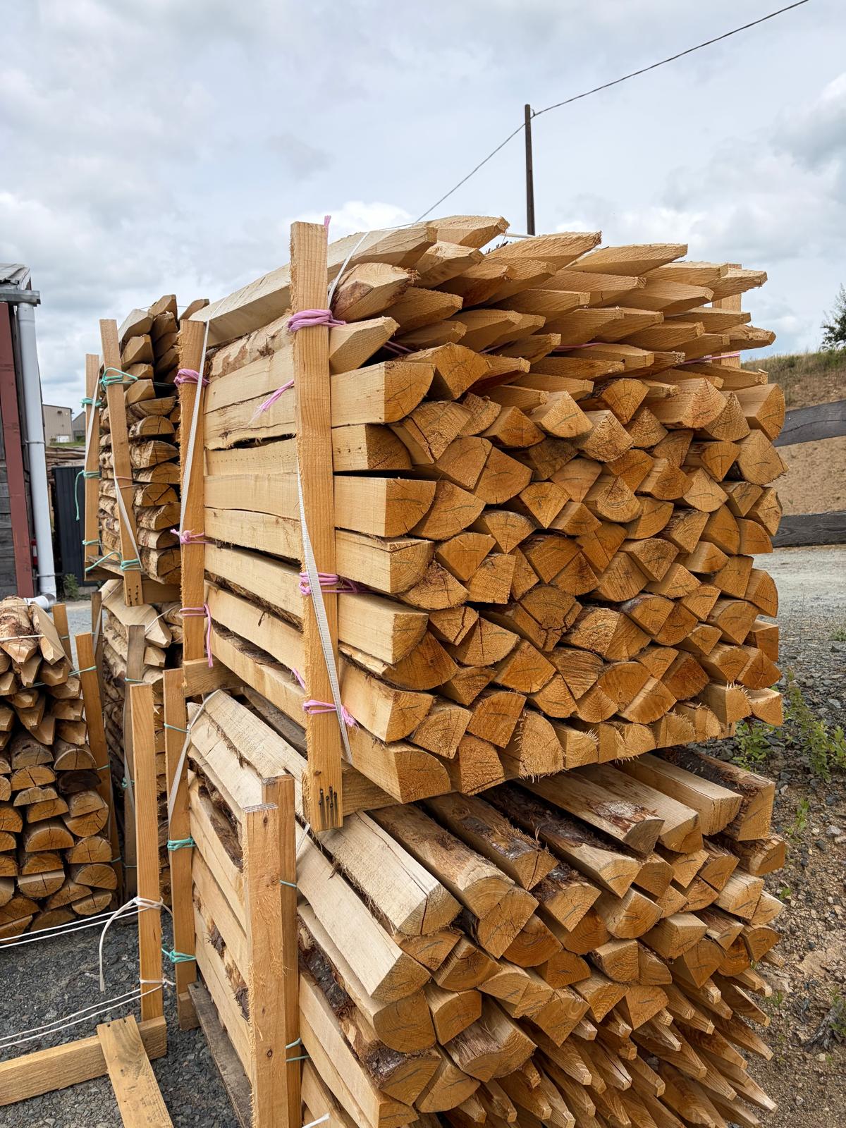 Split chestnut quarter-poles for agricultural and equestrian fencing, and landscaping.